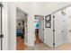 Well-lit hallway with tile flooring, connecting to various rooms, including a bedroom and laundry area at 462 Lakepark Trl, Oviedo, FL 32765