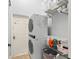 Convenient laundry room features a stackable washer and dryer and ample shelving for storage at 462 Lakepark Trl, Oviedo, FL 32765