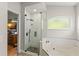 Contemporary bathroom with glass shower enclosure, rain shower head and pebble floor at 462 Lakepark Trl, Oviedo, FL 32765