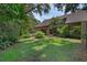 Expansive backyard features lush lawn and mature trees providing shade and privacy at 4702 Shorecrest Dr, Orlando, FL 32817