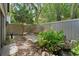 Tranquil backyard featuring established trees, a pond, and a stone bench at 4702 Shorecrest Dr, Orlando, FL 32817