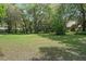 Large backyard with mature trees and lush greenery provides ample space for outdoor activities at 4702 Shorecrest Dr, Orlando, FL 32817