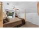 Bedroom with soft colors, window view, ceiling fan, and four-poster bed frame at 4702 Shorecrest Dr, Orlando, FL 32817