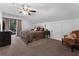 Cozy bedroom with a ceiling fan, a window with curtains, and neutral-colored walls and carpet at 4702 Shorecrest Dr, Orlando, FL 32817