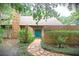 Charming front entrance with a brick wall, stone walkway, and vibrant blue double doors at 4702 Shorecrest Dr, Orlando, FL 32817