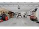 Spacious garage with a multitude of storage options and containing an additional refrigerator at 4702 Shorecrest Dr, Orlando, FL 32817