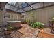 Private covered patio with tiled floor, hot tub, tropical plants, and outdoor lighting at 4702 Shorecrest Dr, Orlando, FL 32817
