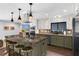 Modern kitchen with a granite island, stainless steel appliances, and custom cabinetry at 4702 Shorecrest Dr, Orlando, FL 32817