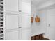 Bright mudroom features custom cabinets, wine racks, and a convenient bench with storage at 4702 Shorecrest Dr, Orlando, FL 32817