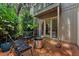 Private brick patio with firepit and comfortable seating, surrounded by lush landscaping at 4702 Shorecrest Dr, Orlando, FL 32817