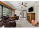 Relaxing sunroom with comfortable seating, fireplace, and bright windows offering a nature view at 4702 Shorecrest Dr, Orlando, FL 32817