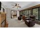 Inviting sunroom with comfortable seating, fireplace, and bright windows offering a nature view at 4702 Shorecrest Dr, Orlando, FL 32817