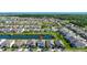 Aerial view of the lakeside community with a two-story home on a beautiful summer day at 4908 Lotta Ct, St Cloud, FL 34772