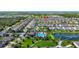 An aerial view of a Primary-planned community with a community pool, lake access, boat ramp, and lush landscaping at 4908 Lotta Ct, St Cloud, FL 34772