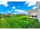 Expansive backyard featuring manicured lawn, a lake view, and a covered patio perfect for relaxation at 4908 Lotta Ct, St Cloud, FL 34772