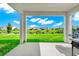 Serene backyard with lake view framed by covered patio columns, includes a grill for outdoor cooking at 4908 Lotta Ct, St Cloud, FL 34772