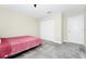 Bright bedroom includes a closet and another door, complemented by soft carpet flooring at 4908 Lotta Ct, St Cloud, FL 34772