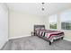 Bright, carpeted bedroom featuring natural light and modern decor with stylish accents at 4908 Lotta Ct, St Cloud, FL 34772