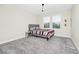 Well-lit bedroom featuring soft carpet, large windows, and a cozy modern decor at 4908 Lotta Ct, St Cloud, FL 34772