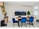 Bright dining area featuring a large aquarium, modern light fixture, and blue velvet chairs at 4908 Lotta Ct, St Cloud, FL 34772