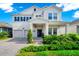 Charming two-story home featuring a two-car garage, blue shutters, and a brick driveway at 4908 Lotta Ct, St Cloud, FL 34772