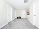 Hallway with multiple doors, carpet, and hanging artwork at 4908 Lotta Ct, St Cloud, FL 34772