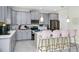 Stylish kitchen with gray cabinets, quartz countertops, stainless steel appliances, and breakfast bar seating at 4908 Lotta Ct, St Cloud, FL 34772