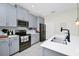 Bright kitchen featuring gray cabinets, stainless steel appliances, and modern fixtures for a sleek design at 4908 Lotta Ct, St Cloud, FL 34772