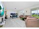 Bright and airy living room featuring comfortable sofas, sleek decor, and a view of the lake at 4908 Lotta Ct, St Cloud, FL 34772