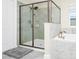 Glass shower in bathroom with gray tiling and white tub at 4908 Lotta Ct, St Cloud, FL 34772