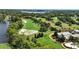 Aerial view of neighborhood golf course, with lakes and mature landscaping, and a house in the foreground at 5074 Isleworth Country Club Dr, Windermere, FL 34786