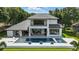 A modern backyard featuring a large pool, spa, and covered patio, perfect for outdoor relaxation and entertaining at 5074 Isleworth Country Club Dr, Windermere, FL 34786