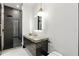 Modern bathroom with a luxurious marble countertop and a glass-enclosed shower at 5074 Isleworth Country Club Dr, Windermere, FL 34786