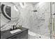 Stylish bathroom with marble walls, glass shower, and modern fixtures at 5074 Isleworth Country Club Dr, Windermere, FL 34786