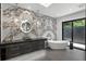 This bathroom boasts a modern tub, beautiful marble accent wall, and sleek vanity at 5074 Isleworth Country Club Dr, Windermere, FL 34786