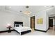 A comfortable bedroom with a modern light fixture leads to a closet area at 5074 Isleworth Country Club Dr, Windermere, FL 34786