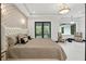 Bright bedroom featuring a decorative accent wall, king bed, and balcony access at 5074 Isleworth Country Club Dr, Windermere, FL 34786