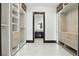 Walk-in closet with custom shelving and drawers leads to a modern bathroom at 5074 Isleworth Country Club Dr, Windermere, FL 34786