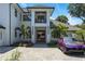 Luxury home featuring a unique gold accented door, pristine landscaping, and a paved drive leading to the grand entrance at 5074 Isleworth Country Club Dr, Windermere, FL 34786