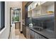 A modern butler's pantry kitchen features stainless steel appliances and dark cabinets and stylish countertops at 5074 Isleworth Country Club Dr, Windermere, FL 34786