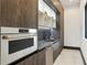 A modern butler's pantry kitchen features stainless steel appliances and dark cabinets and stylish countertops at 5074 Isleworth Country Club Dr, Windermere, FL 34786