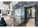 A spacious kitchen features a long island with seating and modern appliances and adjacent living area at 5074 Isleworth Country Club Dr, Windermere, FL 34786