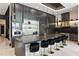 A modern kitchen features a large island with seating and stainless steel appliances and dark cabinets at 5074 Isleworth Country Club Dr, Windermere, FL 34786