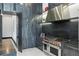 A modern kitchen features stainless steel appliances, gas range and dark cabinets with stylish countertops at 5074 Isleworth Country Club Dr, Windermere, FL 34786