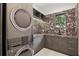 Modern laundry room with granite countertops, state-of-the-art washer/dryer, and storage at 5074 Isleworth Country Club Dr, Windermere, FL 34786