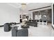A modern living room features black modern-style furniture and light-colored flooring with adjacent kitchen at 5074 Isleworth Country Club Dr, Windermere, FL 34786