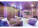 A plush media room with custom lighting, seating, and a large screen TV at 5074 Isleworth Country Club Dr, Windermere, FL 34786