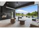 Outdoor living space with a kitchen overlooking the pool and golf course at 5074 Isleworth Country Club Dr, Windermere, FL 34786
