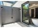 This outdoor shower features a rainfall shower head and textured wall detail at 5074 Isleworth Country Club Dr, Windermere, FL 34786