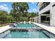 Stunning pool with stepping stones, adjacent to the house and surrounded by lush greenery and a patio at 5074 Isleworth Country Club Dr, Windermere, FL 34786